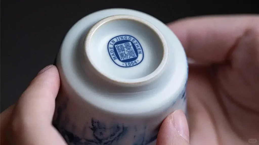 Professional analysis of ceramic plates: safety, heat resistance, quality, and Chinese manufacturing 7 a hand holding a small white and blue bowl